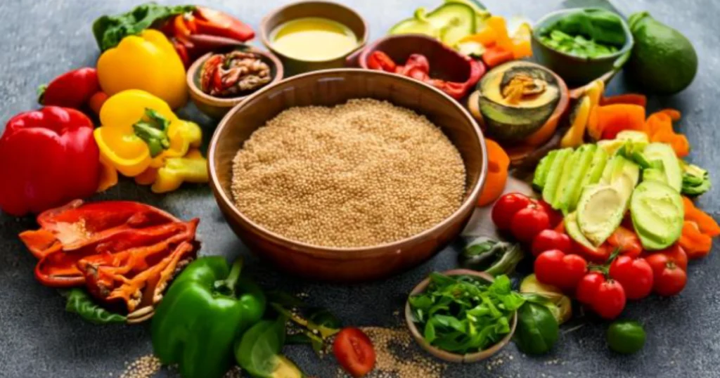 A selection of fresh ingredients for a quinoa bowl, featuring a central bowl of uncooked quinoa surrounded by colorful vegetables like bell peppers, avocado, tomatoes, and herbs, ready for preparation